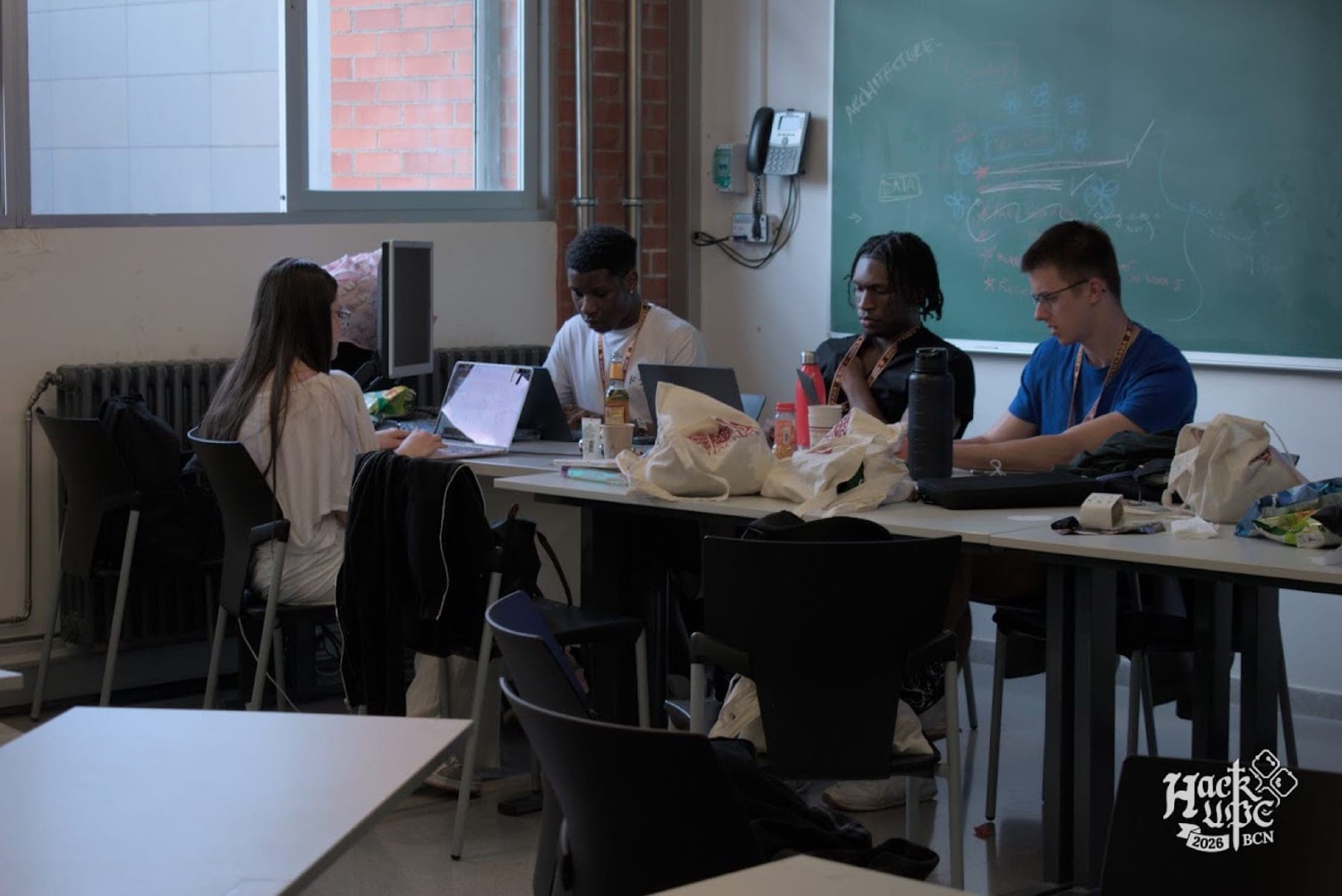 The SafeHaven team working at laptops in a classroom during HackUPC 2026 in Barcelona.